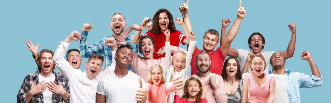 Group of people expressing joy with arms in the air