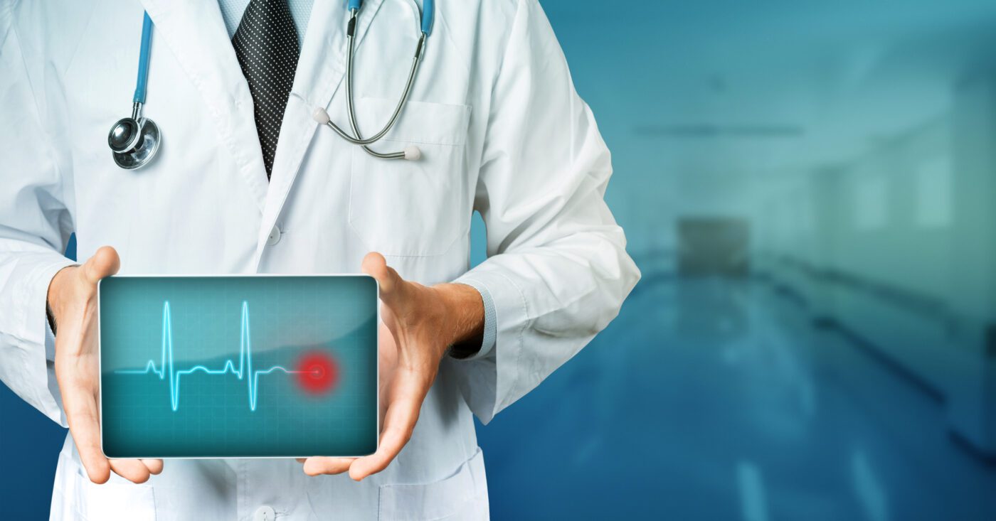 Doctor holding a screen displaying a heartbeat